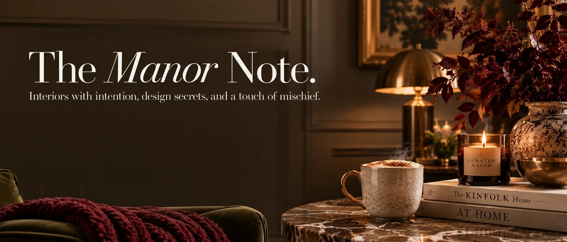 The Manor Note &mdash; Curated Manor&rsquo;s monthly letter: a styled corner of a dark panelled room with a lit candle, a speckled mug and autumn branches